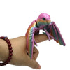 A hand holds a colorful 3D printed parrot figurine with movable wings.