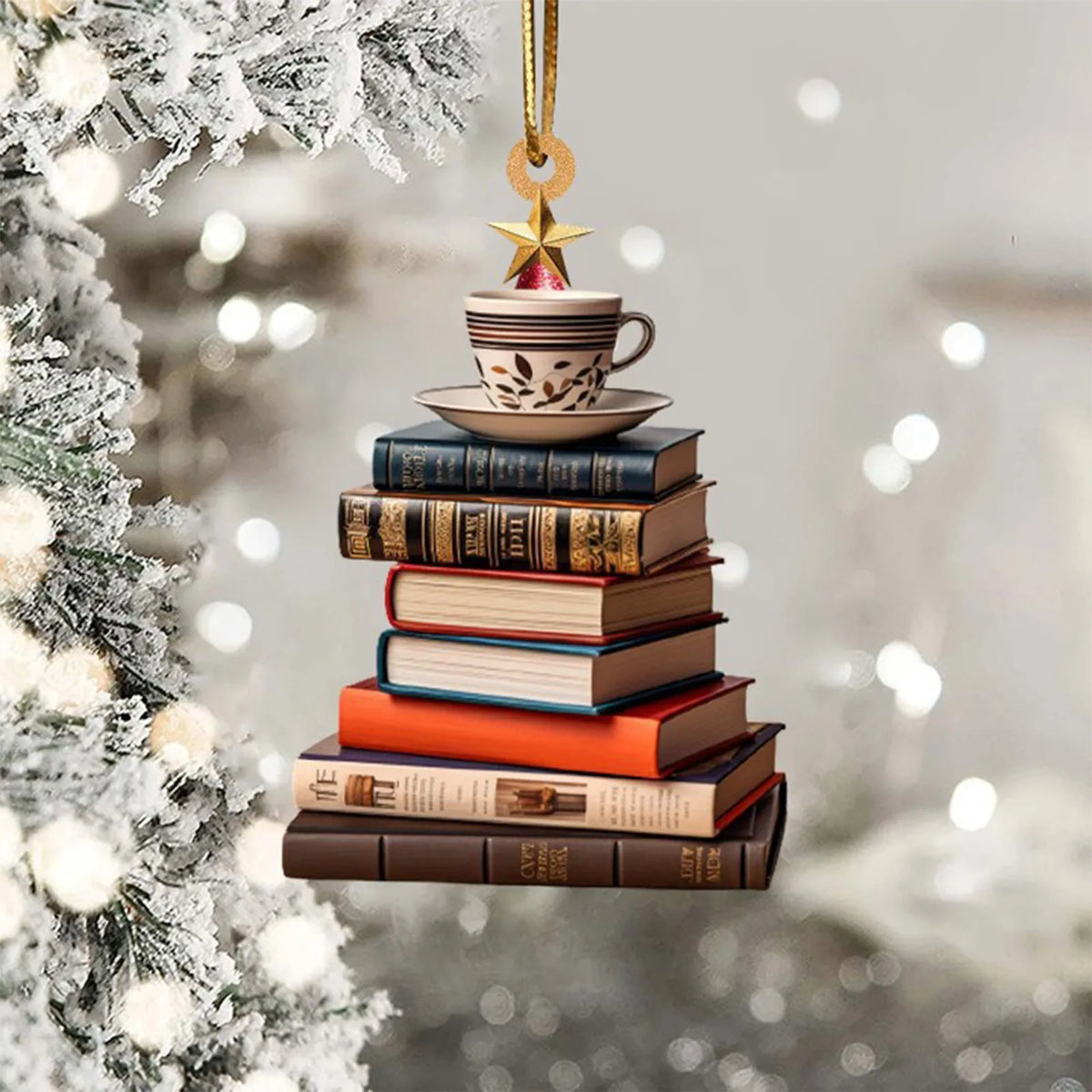 Ornement en forme d'arbre à livres et thé, avec une tasse suspendue à une étoile dorée.