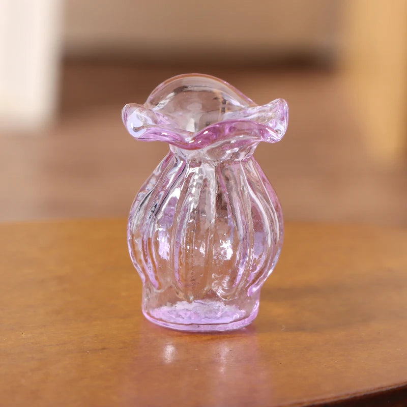 A small, translucent purple glass vase shaped like a stylized flower sits on a wooden surface.