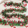 A festive Christmas tinsel garland featuring red and green branches with Santa figures for holiday decor.