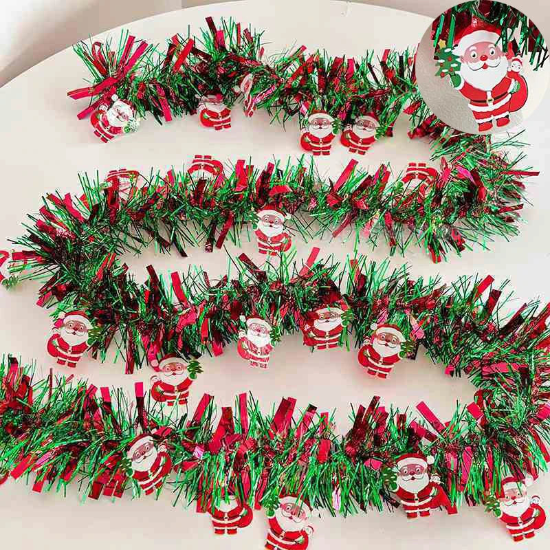 A festive Christmas tinsel garland featuring red and green branches with Santa figures for holiday decor.