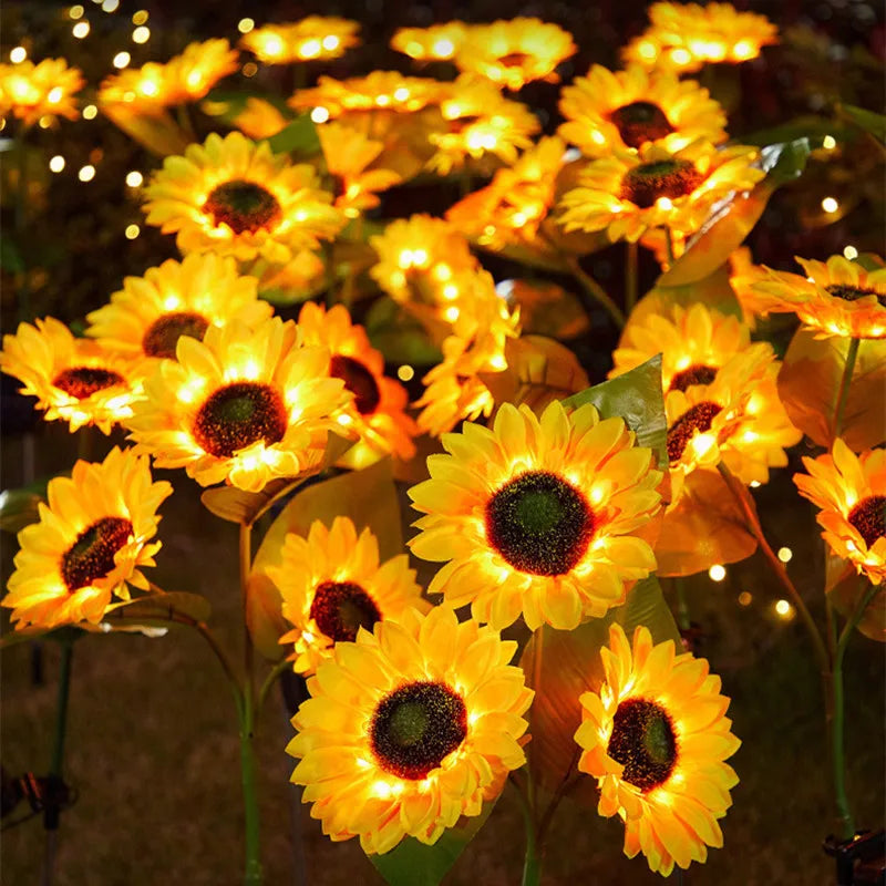 Bright yellow solar sunflower LED garden lights blooming in the dark.
