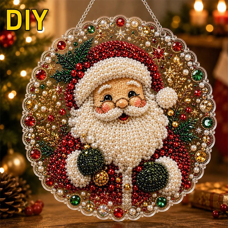 A Christmas Santa face made of pearls and glitter is set within a clear diamond painting suncatcher with a metal chain.