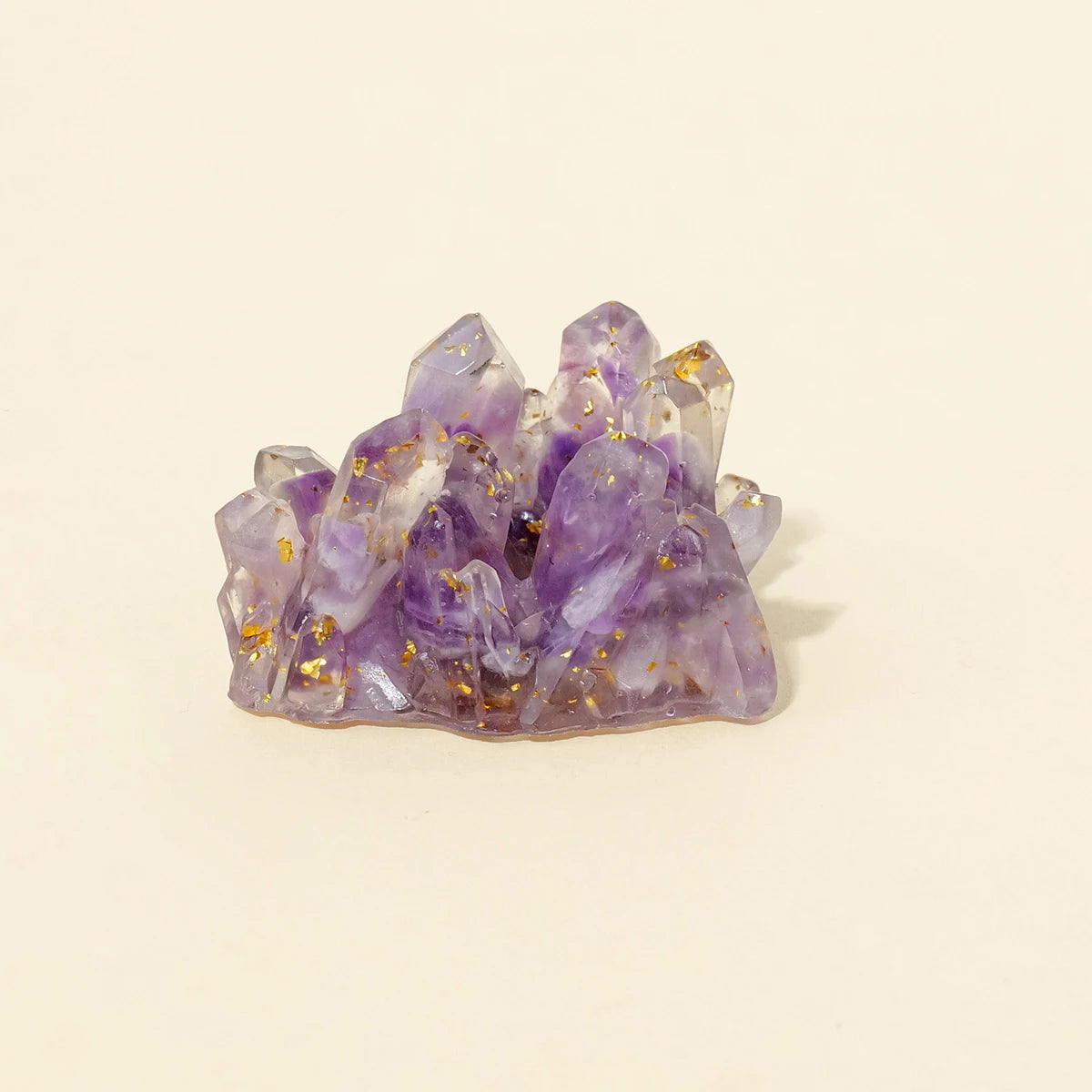 A cluster of purple amethyst crystals used as a Reiki amulet or decorative figurine.