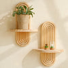 Geometric wooden wall shelves displaying a potted plant and a glass terrarium.