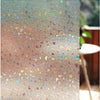 Close-up of frosted window privacy film with iridescent glitter particles scattered across the surface.