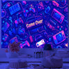 A dark blue tapestry featuring various game controllers and electronic accessories with glowing UV reactive elements.