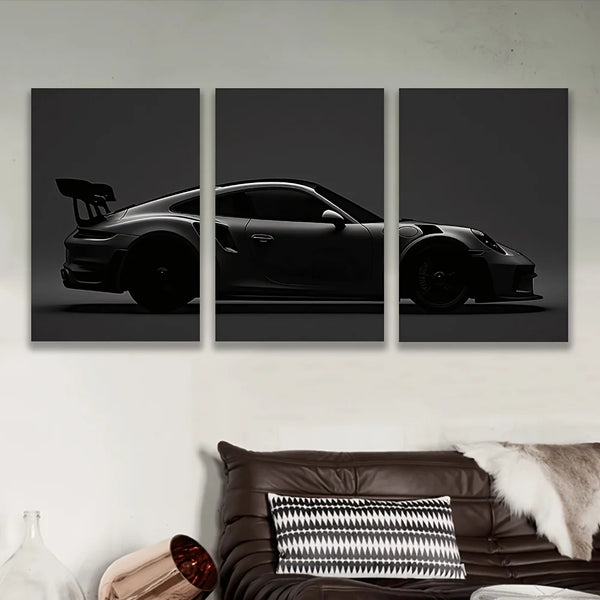Three panels of black sports car silhouette canvas wall art displayed on a white wall.