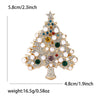 A gold-toned rhinestone Christmas tree brooch featuring white pearls and colored gemstones.