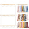 Wall-mounted headband holder displaying various colored fabric headbands.