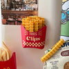 A plastic container filled with decorative French fry shaped sealing clips in a red and yellow checkered pattern.