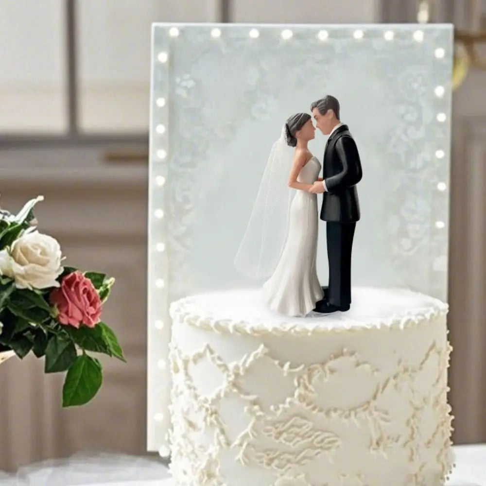 Elegant bride and groom cake topper featuring a couple embracing against a white floral background