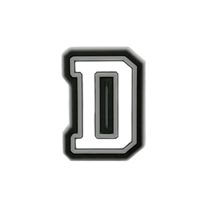 Charm à chaussure en forme de lettre D, noir et blanc.