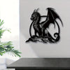 A black metal wall sculpture of a dragon with wings inside a circular frame.
