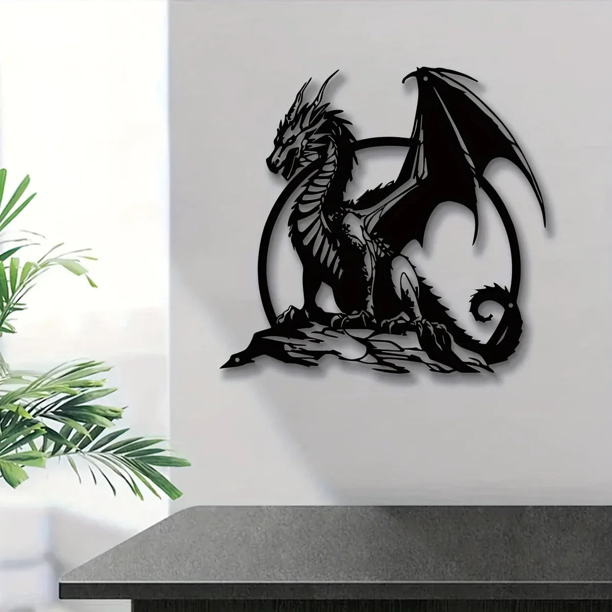 A black metal wall sculpture of a dragon with wings inside a circular frame.