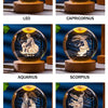 A set of seven crystal balls engraved with zodiac signs, including Leo, Capricornus, Aquarius, Scorpius, Gemini, and Taurus.