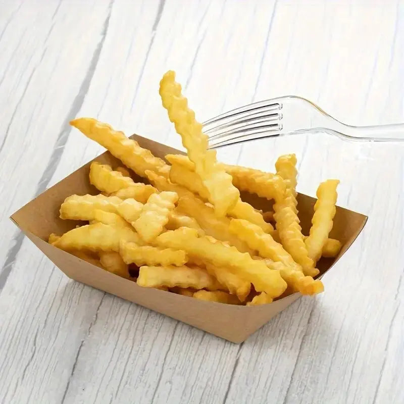 A pile of golden french fries served in a brown paper container with a silver fork nearby.