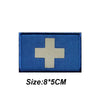 A blue fabric patch with a white cross design, measuring 8 by 5 centimeters.