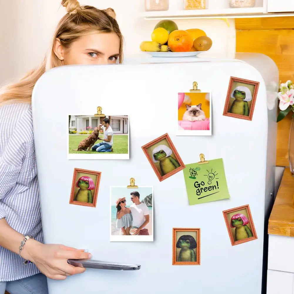 A woman holds a wooden frog photo frame magnet with various hair styles displayed on a refrigerator.