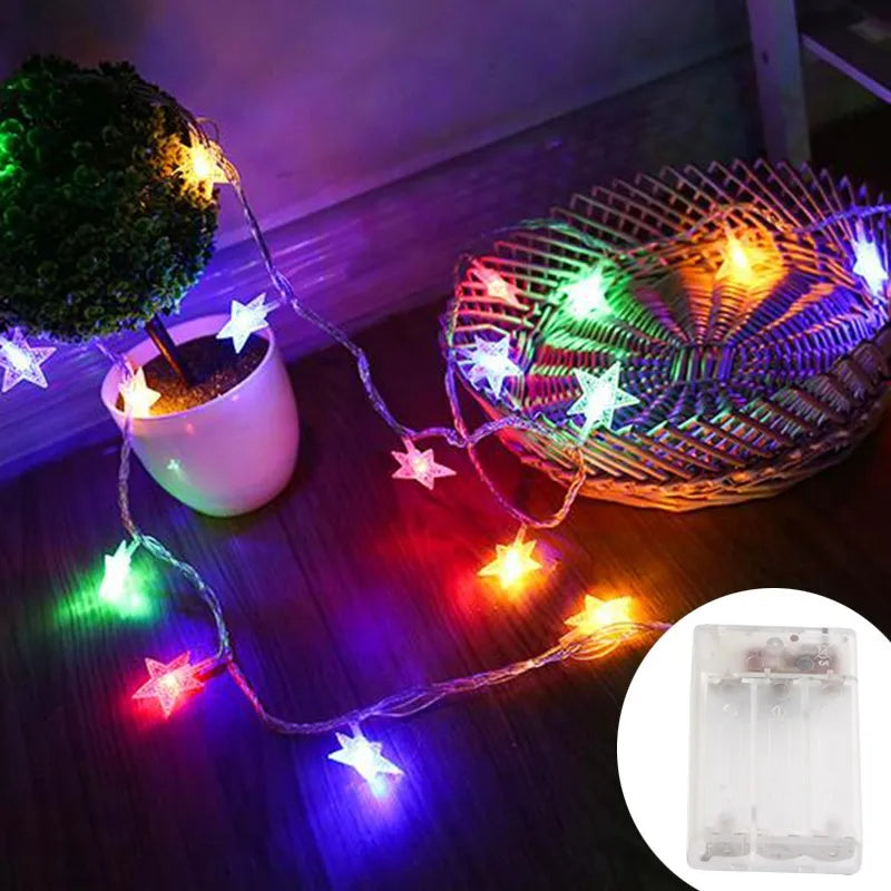 String lights with star-shaped LED fairy lights illuminating a woven basket and a white mug