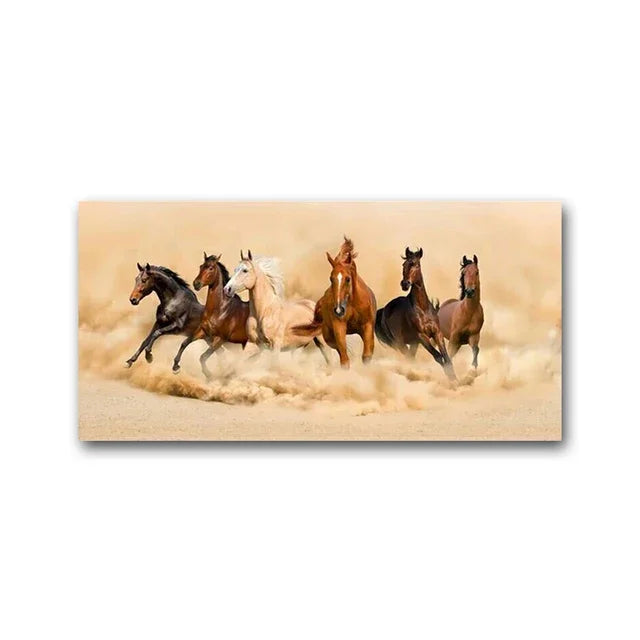 A group of horses galloping across a sandy beach, creating a cloud of dust.