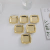 A collection of ten small, gold-colored mirror-finish trays for jewelry, snacks, or decor.