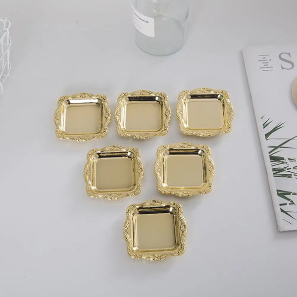 A collection of ten small, gold-colored mirror-finish trays for jewelry, snacks, or decor.