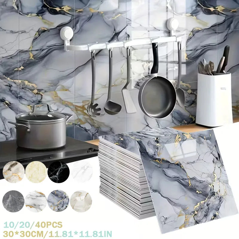 Silver kitchen utensils hanging on a marble-patterned backsplash with a decorative marble slab.
