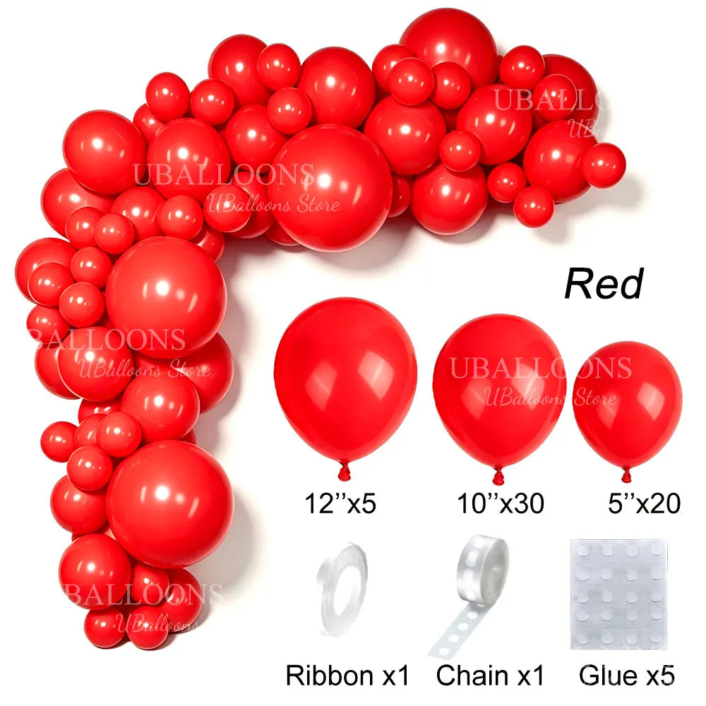 A collection of red latex balloons, ribbons, chains, and glue for party decor.