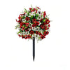 A bouquet of red and white artificial petunias with a black ground stake.
