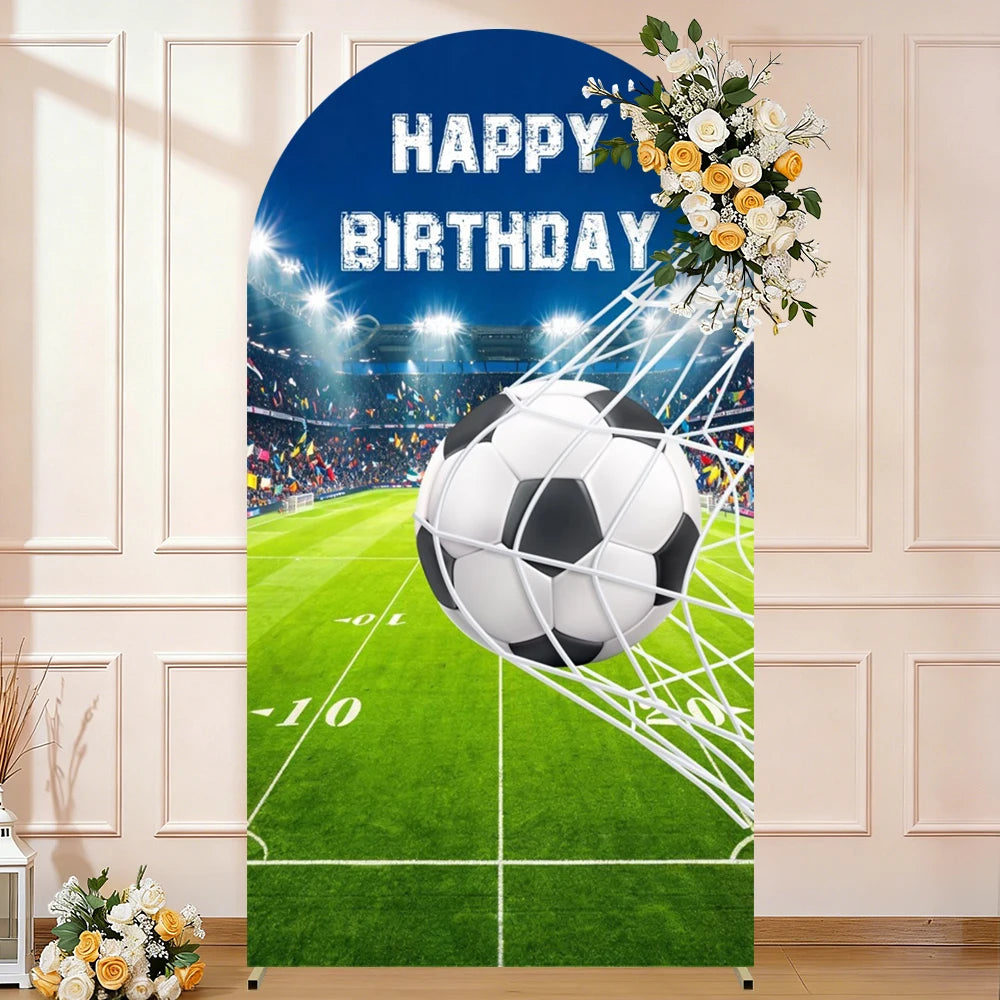 A blue arch backdrop featuring a soccer ball and text wishing a happy birthday on a green field background