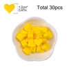 A bowl filled with 30 yellow silicone heart beads for DIY jewelry making
