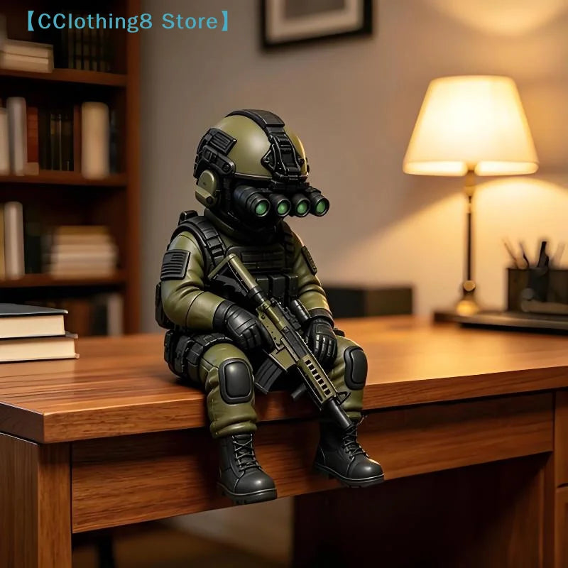 A detailed resin collectible statue of a tactical sniper soldier in olive green military gear sitting on a wooden desk.