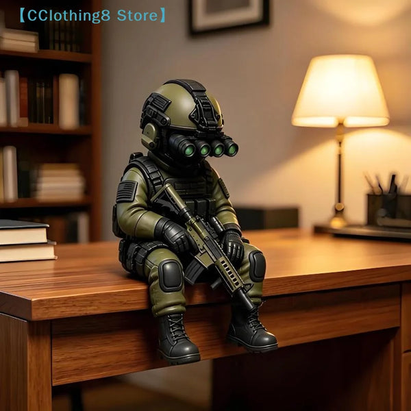 A detailed resin collectible statue of a tactical sniper soldier in olive green military gear sitting on a wooden desk.
