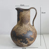 A vintage dual-sided ceramic vase with a mottled brown and black glaze, shown against a white background.