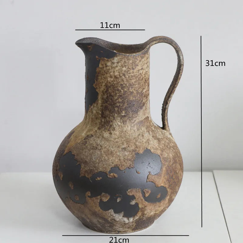 A vintage dual-sided ceramic vase with a mottled brown and black glaze, shown against a white background.