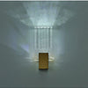 Modern bubble crystal LED wall sconces illuminating a rectangular gold panel.
