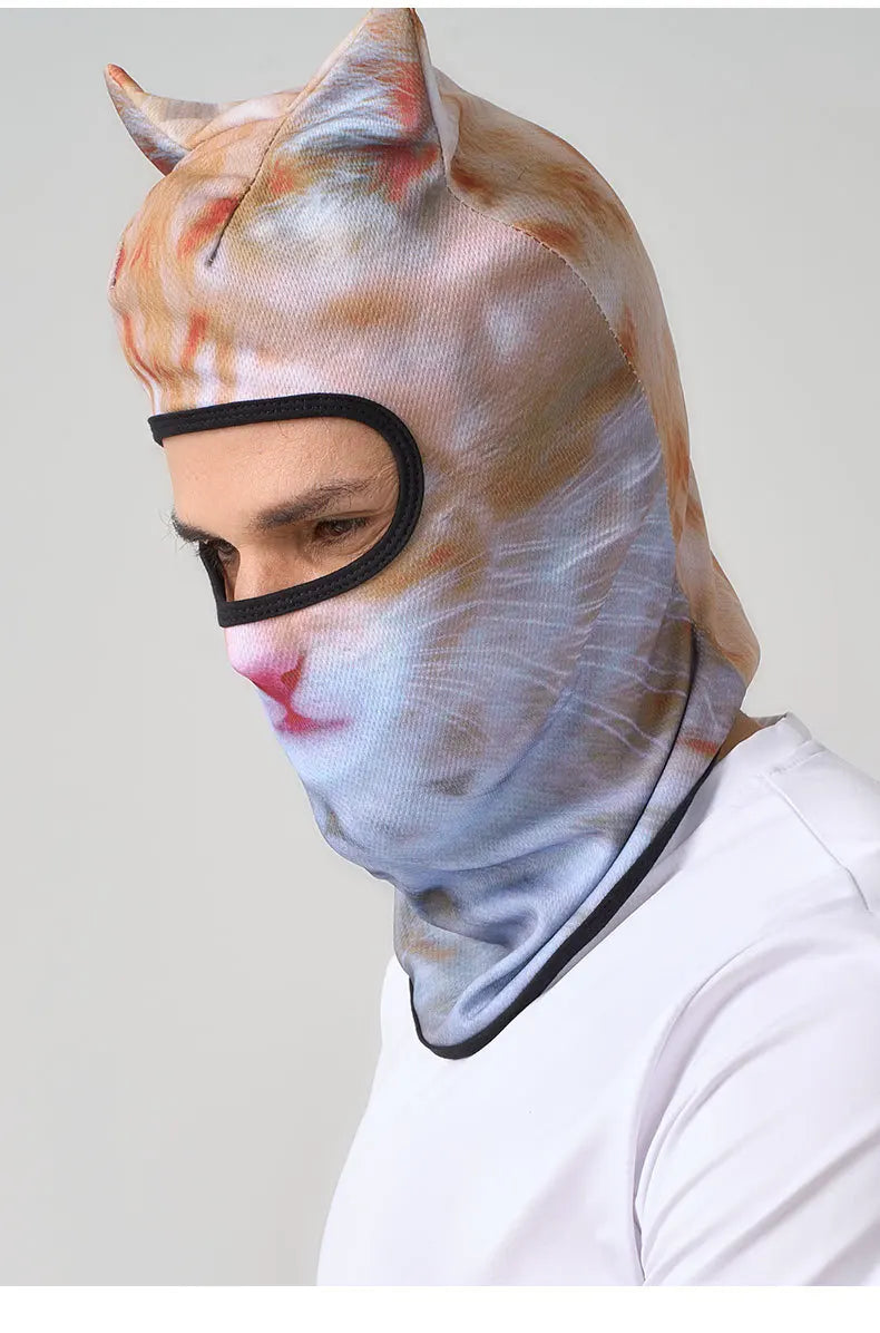 A person wearing an orange and white cat face balaclava with ears.