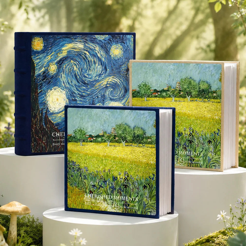 A set of three blue and green laminated photo albums featuring starry night skies and fields of yellow flowers.