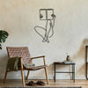 A minimalist line art illustration of a person sitting and holding a book on a light beige wall.