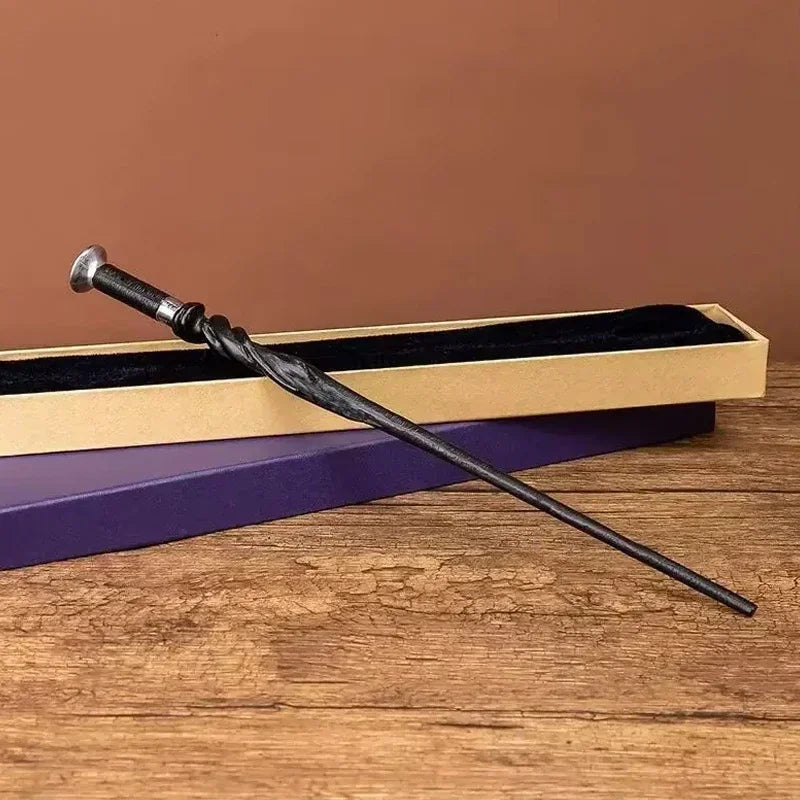 A dark metal magic wand rests diagonally across a wooden box with a purple lining on a rustic table.