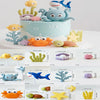 A set of ocean animal cake toppers including a whale, octopus, and turtle in various colors.