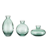 A set of three minimalist glass bud vases in varying sizes and shades of seafoam green.