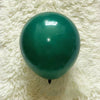 A single, glossy teal latex balloon resting on a white, fluffy surface.