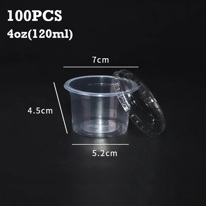 A set of 100 disposable clear plastic sauce cups with lids shown next to a measurement scale.