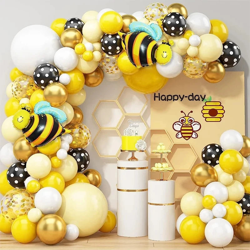 A yellow and black bee themed balloon arch wreath set for birthday parties