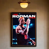 A framed poster featuring a portrait of Dennis Rodman in a basketball uniform.