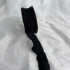 A close-up view of a black decorative fishtail yarn ribbon.