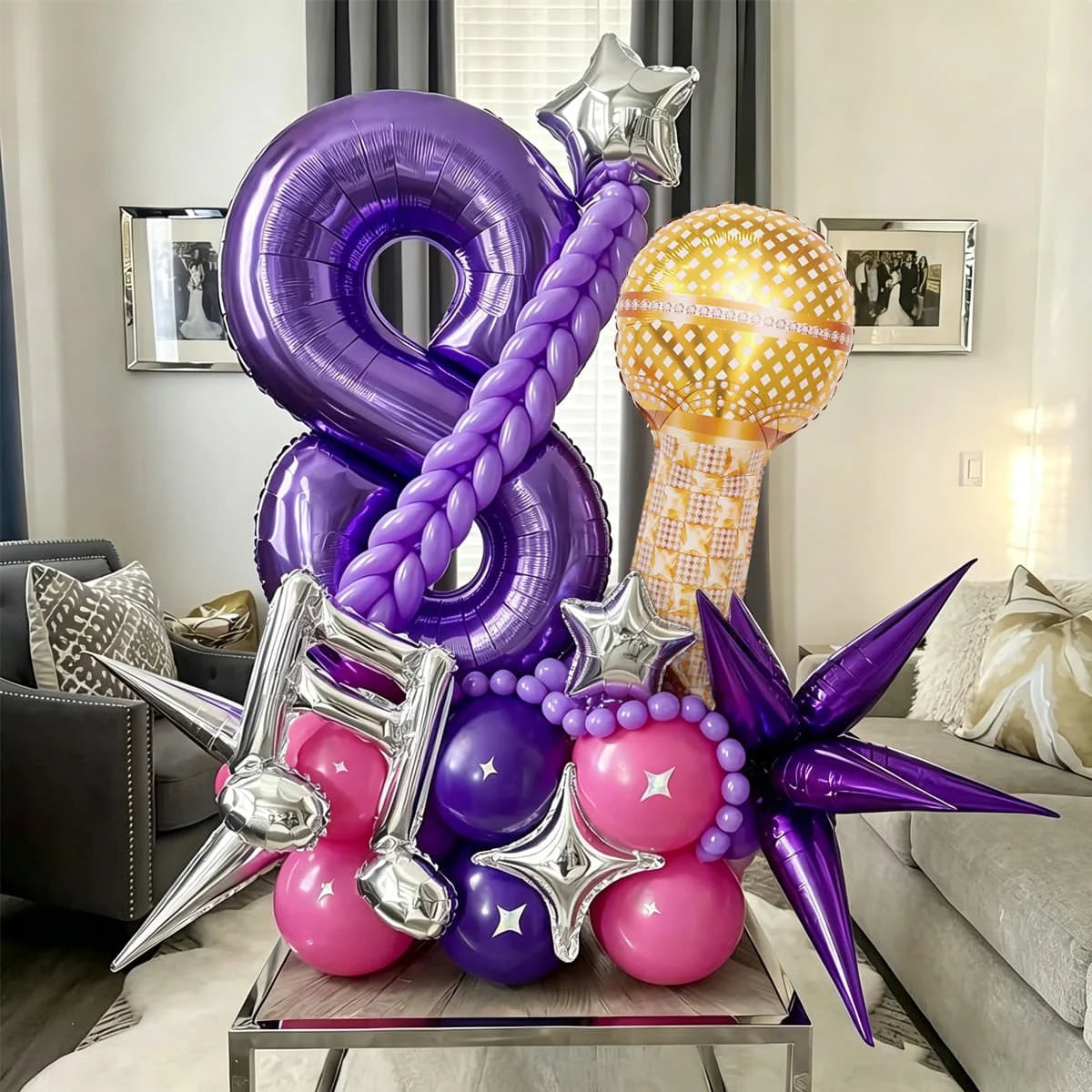 A purple and pink balloon set featuring a large number balloon, star balloons, and round decorative balloons.
