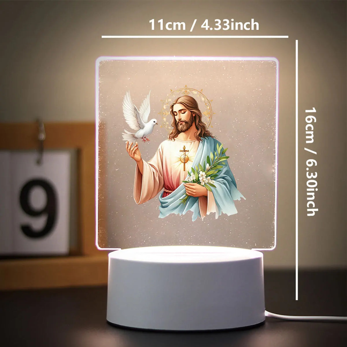 A 3D LED night light featuring a depiction of Jesus with a dove and flowers on a square panel.